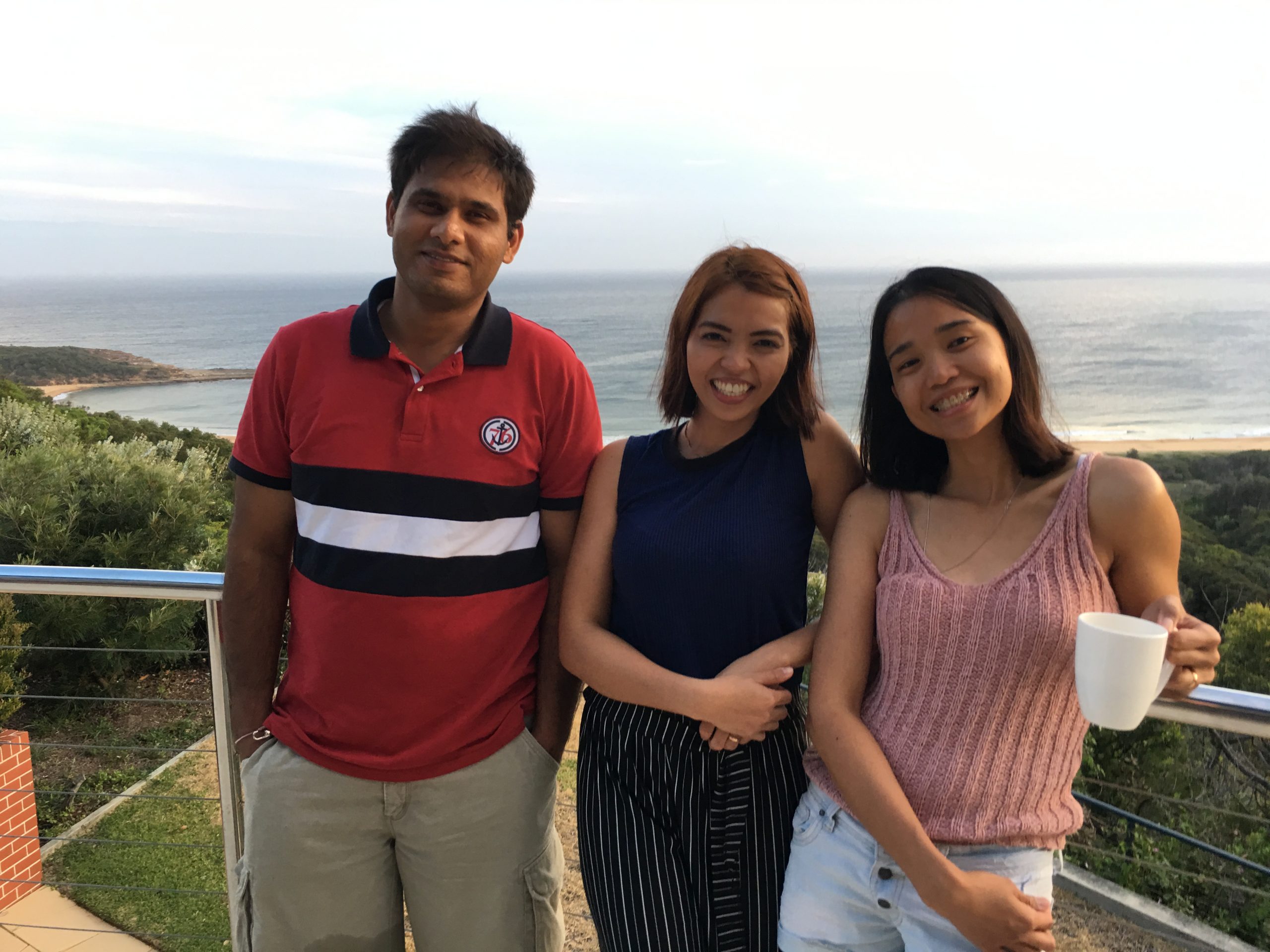 3 members who are apart of Nursing Careers Australia, standing next to each other with land and a sea view behind them