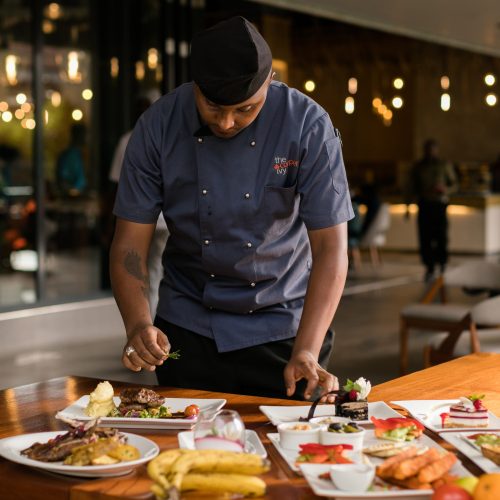Indian chef plating up dishes in Melbourne restaurant