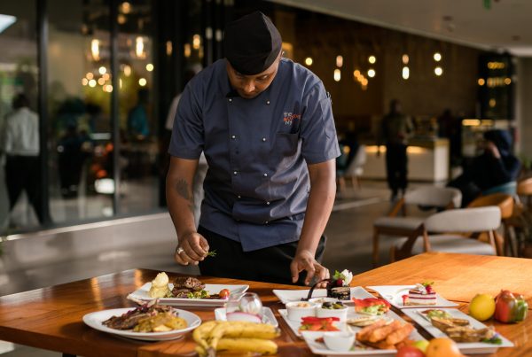 Indian chef plating up dishes in Melbourne restaurant