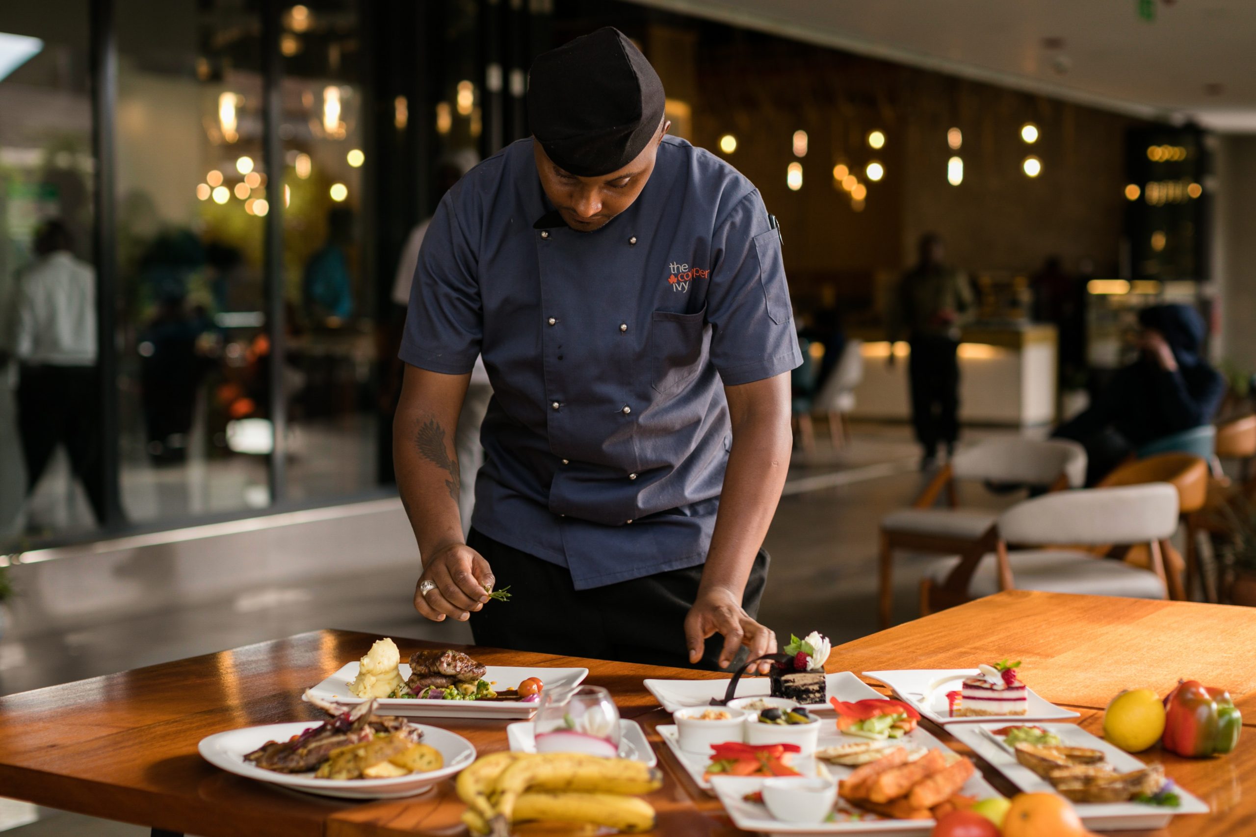 Indian chef plating up dishes in Melbourne restaurant